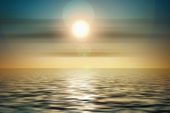 Ondergaande zon in de zee. Staat symbool voor het vinden van rust tijdens deze leiderschapstraining.